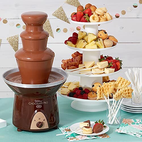 Chocolate fountain with a tiered dessert stand featuring fruits, pastries, and waffles.