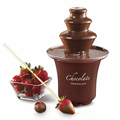 Chocolate fountain with strawberries on skewers.