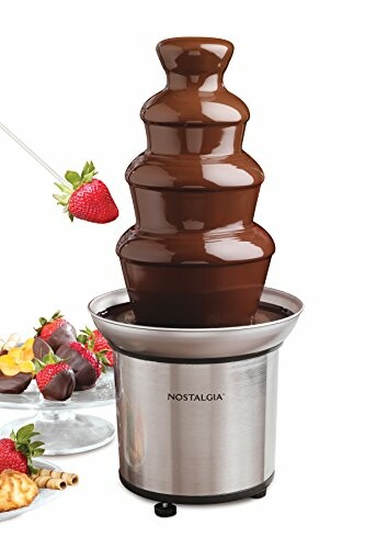 Chocolate fountain with strawberries on skewers.