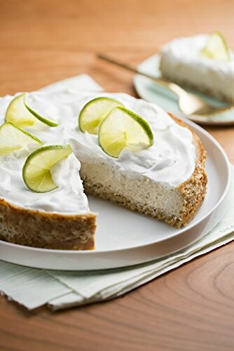 Lime cheesecake with a slice removed on a plate